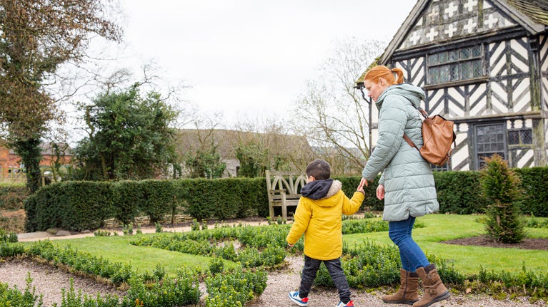 A family enjoying the gardens at Little Moreton Hall, Cheshire
